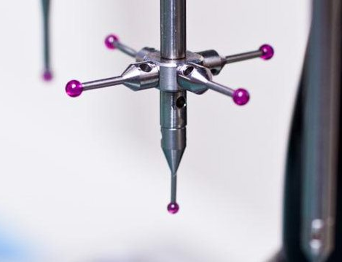 A close up of the four purple knobs on a machine