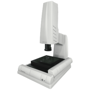 A white and black microscope sitting on top of a table.